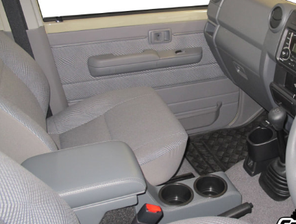 Gray interior of a vehicle with console, steering wheel, and dashboard.